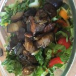 Photo of eggplant salad in a glass bowl.