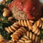 Vegan meatballs with marinara, pasta and kale.