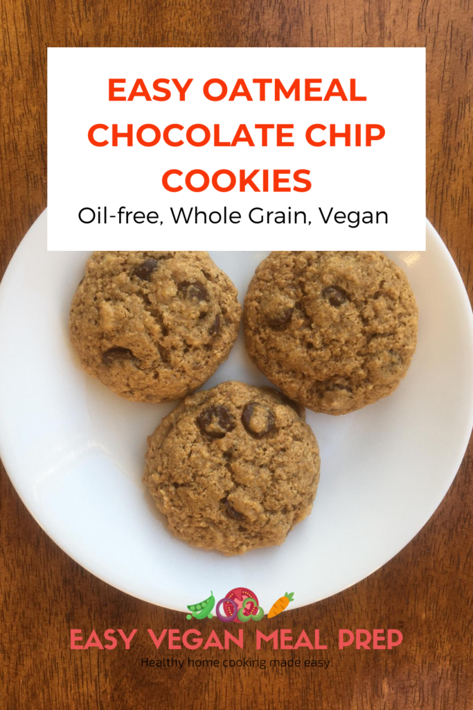 Photo with caption "Easy oatmeal chocolate chip cookies oil-free, whole grain, vegan. easyveganmealprep.com. Background photo of three delicious cookies on a plate on a wooden table.